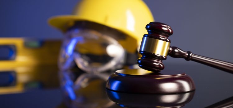 gavel in front of hard hat and goggles