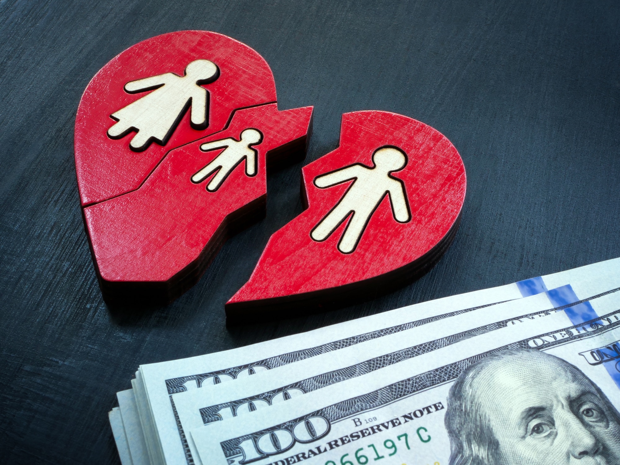 Broken heart with family and cash. Alimony concept.