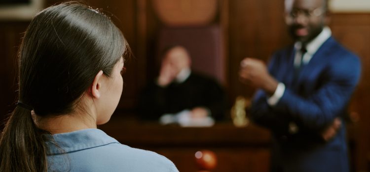 Young Caucasian Woman Testifying in Courtroom with Black Man Questioning